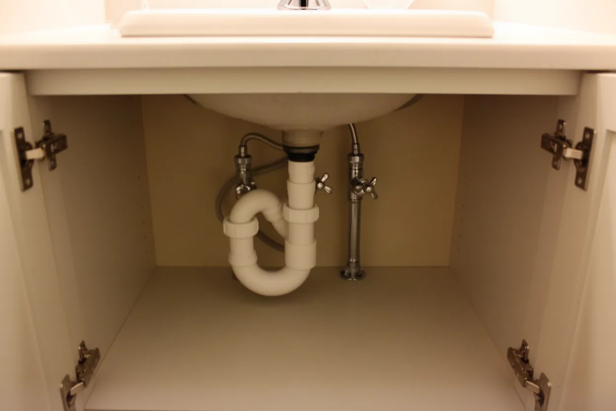 Drain trap and supply lines under a vanity sink
